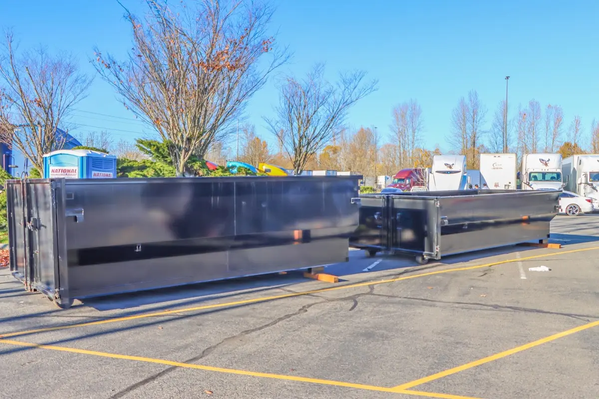 Professional dumpster rental service with roll-off container on residential driveway in West Covina